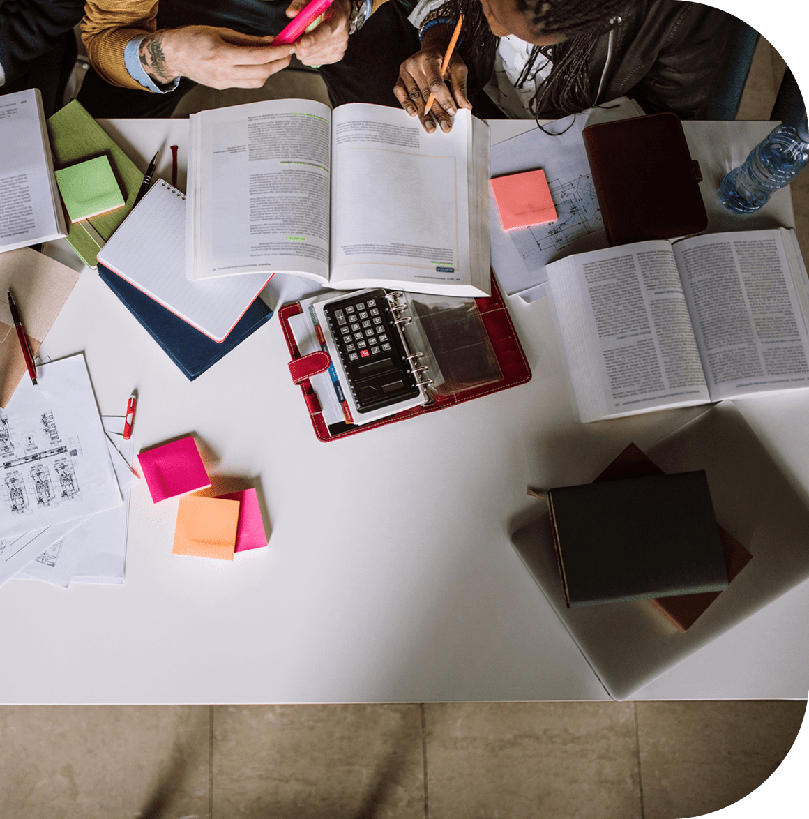 Studying materials with books and sticky notes.