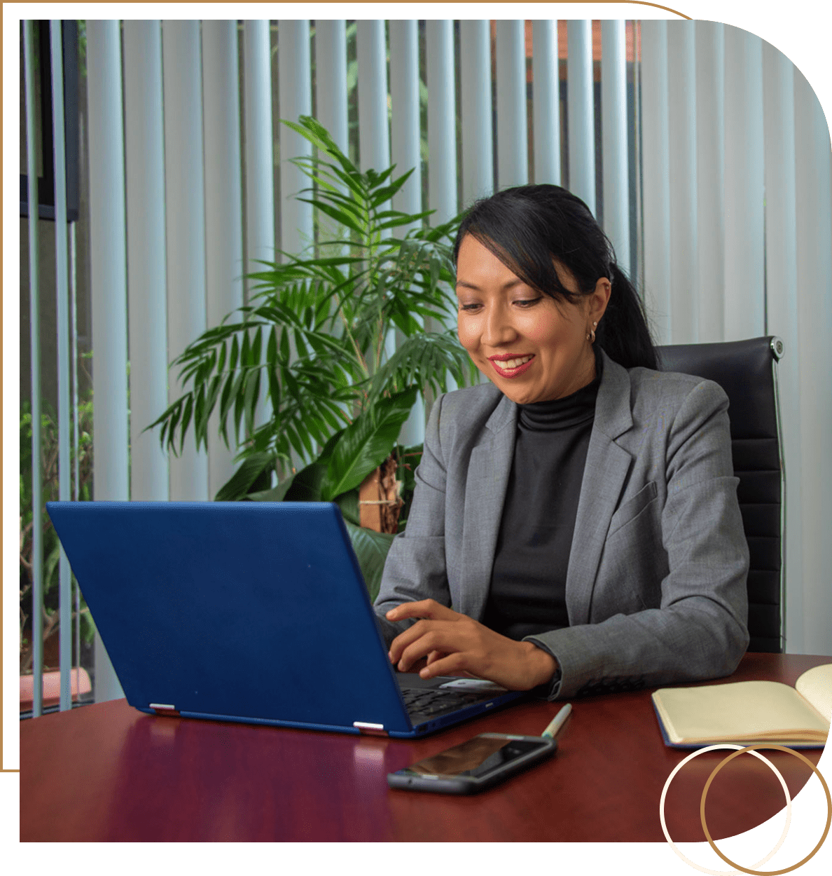 Businesswoman working on laptop in office.